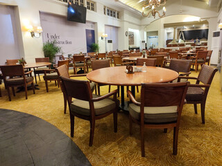 wooden tables and chairs are neatly arranged in the restaurant
