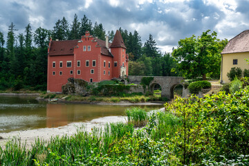 Naklejka na ściany i meble The old castle Červená lhota in South Bohemia. A castle with a brick bridge over a lake. Tourist attraction in the Czech Republic.