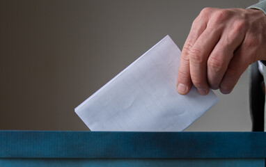 European Union parliament election concept -  hand putting ballot in blue election box
