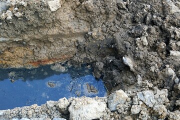 A broken water pipe on a construction site, pollution and environment concepts.