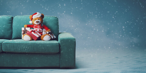 Cute teddy bear with Santa hat on the couch - obrazy, fototapety, plakaty