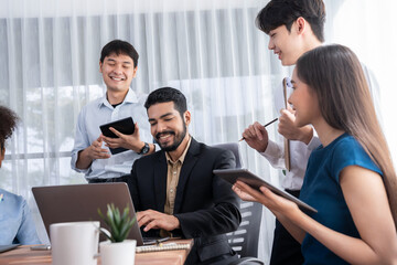 Fototapeta na wymiar Happy diverse business people work together, discussing in corporate office. Professional and diversity teamwork discuss business plan on desk with laptop. Modern multicultural office worker. Concord