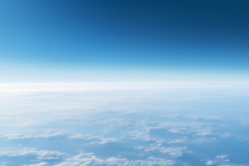 Fototapeta na wymiar aerial view to the blue earth's surface with atmospheric haze and clouds