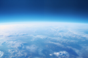 Naklejka na ściany i meble view from the space to the blue earth's surface with atmospheric haze and clouds