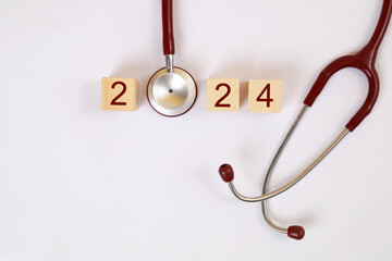 2024 New Year medical concept. 2024 blocks word with stethoscope isolated on white background - obrazy, fototapety, plakaty