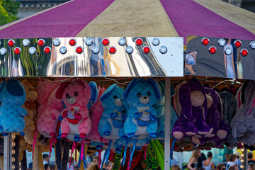Close-up of tent of market stall with stuffed animals and electric lights at fun fair named Zürich...