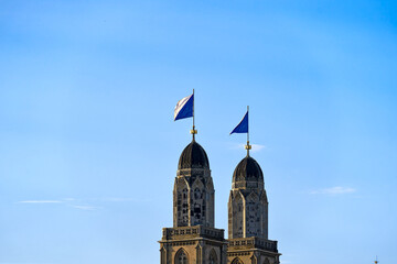Twin towers with flags of City of Zürich and Canton Zürich on top of church towers of protestant...