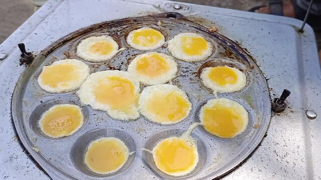 the process of cooking mini omelettes, street food from Indonesia.