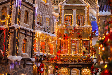 New Year's decorations, toys and garlands on the windows in fabulous scenery. Houses for children in a public place. 