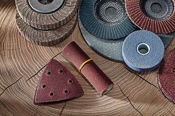Abrasive Wheels And Papers On Wood Background.