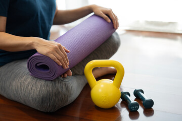 Young woman holding a yoga mat in exercise class for a sport and healthy concept
