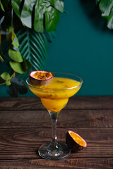 Fresh passion fruit maracuja alcoholic cocktail with ice cubes