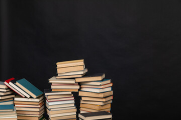 Many stacks of educational books to study in the university library on a background