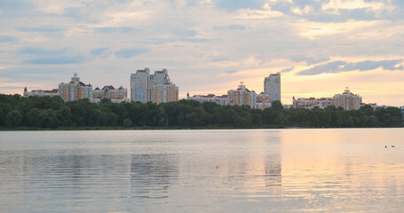 Obraz premium Sunset in big city. Clouds, river, water, buildings. Long video