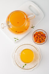 Sea buckthorn tea drink with oranges and mint. Autumn comfort hot drink. Herbal vitamin tea. 