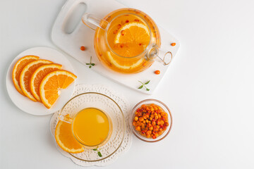 Sea buckthorn tea drink with oranges and mint. Autumn comfort hot drink. Herbal vitamin tea. 