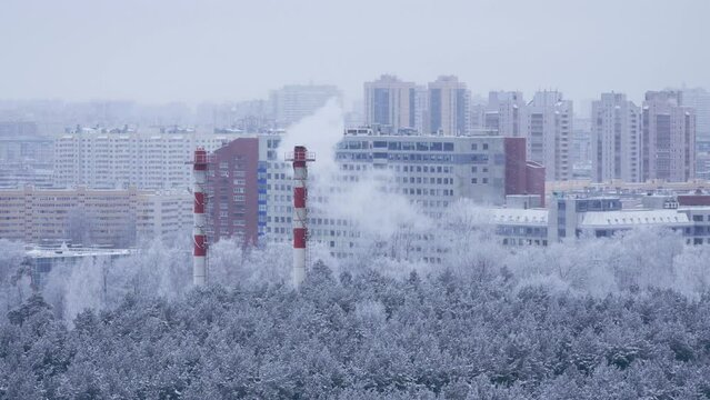 Winter snow urban cityscape with steaming pipes