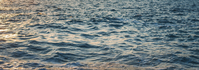 Ripples and waves on the surface of the sea, abstract nature background