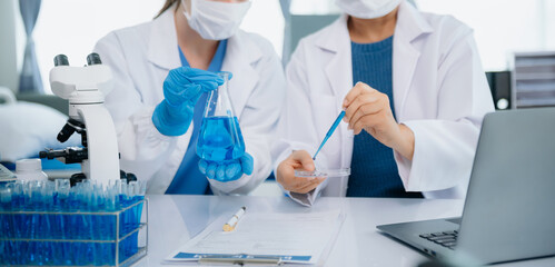 Medical team having a meeting with doctors. Young scientists conducting research investigations in a medical laboratory, a researcher.