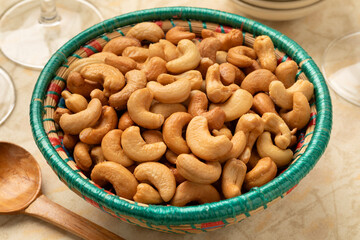 Bowl with salted cashew nuts close up for a snack  