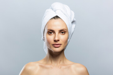 Beautiful girl wearing white towel on her head. Sensuality, wellness and spa concept.