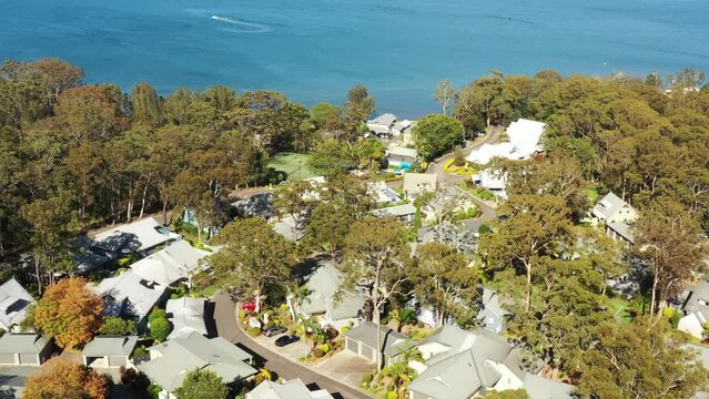 Raffertys resort in Murrays beach on Lake Macquarie – aerial over roofs fly 4k.
