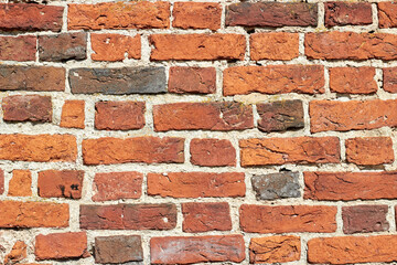 Fototapeta premium Texture of a wall made of ancient red baked bricks