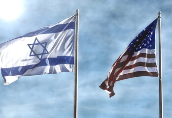 American and Israeli flags waving in the wind together with sun and antique effect