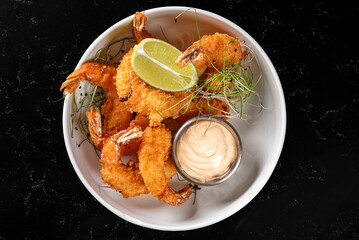 crispy shrimp tempura with garlic sauce on plate