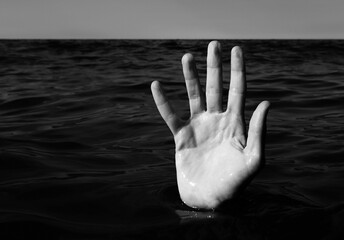 five fingers of the hand of the person who is drowning in the ocean