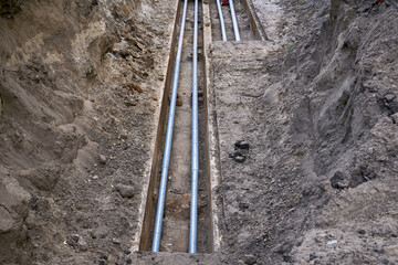 Excavated pit with plastic plumbing sewage pipes for repair and installation