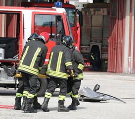 firefighters carrying the injured on a stretcher after the road accident