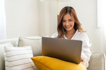 Young smiling asian woman happy relax use laptop conference work,learning, education, shopping, study online, webinar, online marketing, business, blog, digital internet advertising at home.