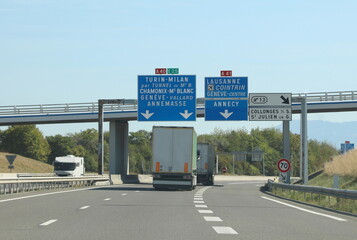 Road sign on the highway with the places French and Italy and indication to MOUNT BLANC