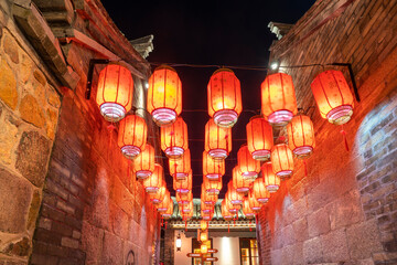 Red lanterns hung on the wall at night