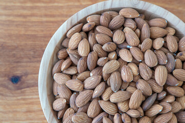 Almond kernel in a bowl. Background view from above. Healthy food
