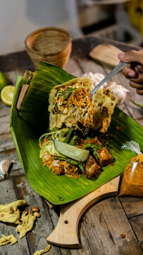 pecel rice as traditional food in Indonesia with tasty and spicy sambal captured with high quality camera.