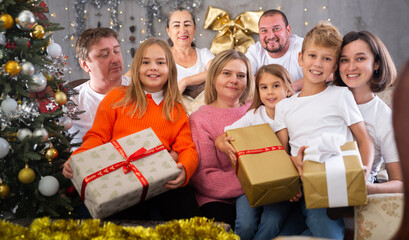 Big family is celebrating New Year together and talking at table indoors
