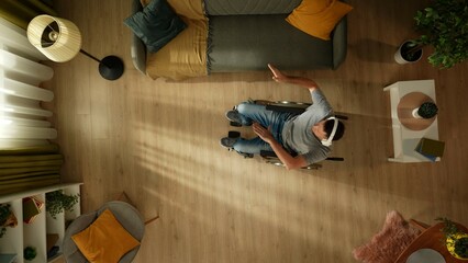 Top view shot a disabled young adult, man with mobility impairment sitting on a wheelchair in a...