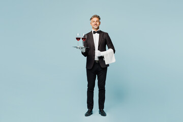 Full body adult barista sommelier male waiter butler man wearing shirt suit bow tie uniform hold...