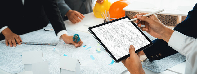 Worker, architect and engineer work on real estate construction project oratory planning with...