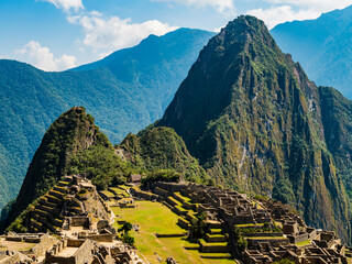 Panoramic view of the lost inca city Machu Picchu, with ruins of the old town, agricultural terraced fields and Huayna Picchu peak in background, Sacred valley of Incas, Cusco region, Peru