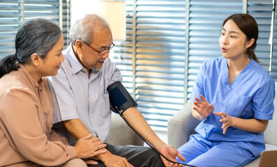 Obraz premium Portrait of smiling caring asian nurse service help support discussing and consulting taking care with senior elderly asian man and woman couple at home visit.senior retirement home care concept