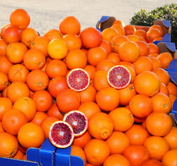 stall with ripe orange oranges some cut in half for sale