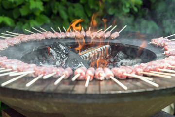 Sausage cooking on a wood brazier