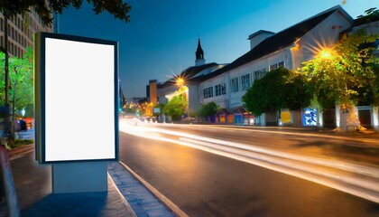 vertical blank white billboard on city street in the background buildings and road mock up poster on street next to roadway beautiful summer night