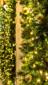 holiday decorations foe christmas and new year with shibibg girland , green fir and pine tree branches and christmas balls