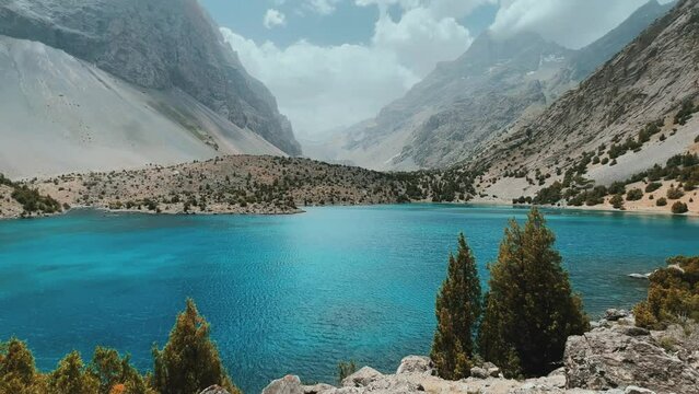 The Alaudin (Chapdara) lakes, lying at an altitude of 2800 m, are considered one of the most beautiful lakes of the Fan Mountains. Turquoise mountain lake. Pamiro-Alai. Tajikistan, Pamir 4K