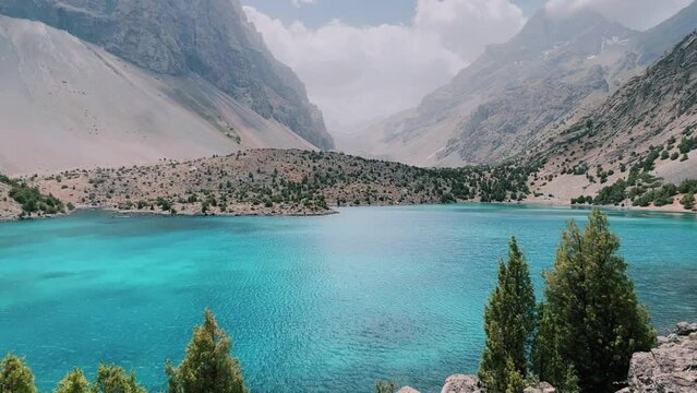 The Alaudin (Chapdara) lakes, lying at an altitude of 2800 m, are considered one of the most beautiful lakes of the Fan Mountains. Turquoise mountain lake. Pamiro-Alai. Tajikistan, Pamir 4K