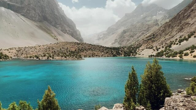 The Alaudin (Chapdara) lakes, lying at an altitude of 2800 m, are considered one of the most beautiful lakes of the Fan Mountains. Turquoise mountain lake. Pamiro-Alai. Tajikistan, Pamir 4K